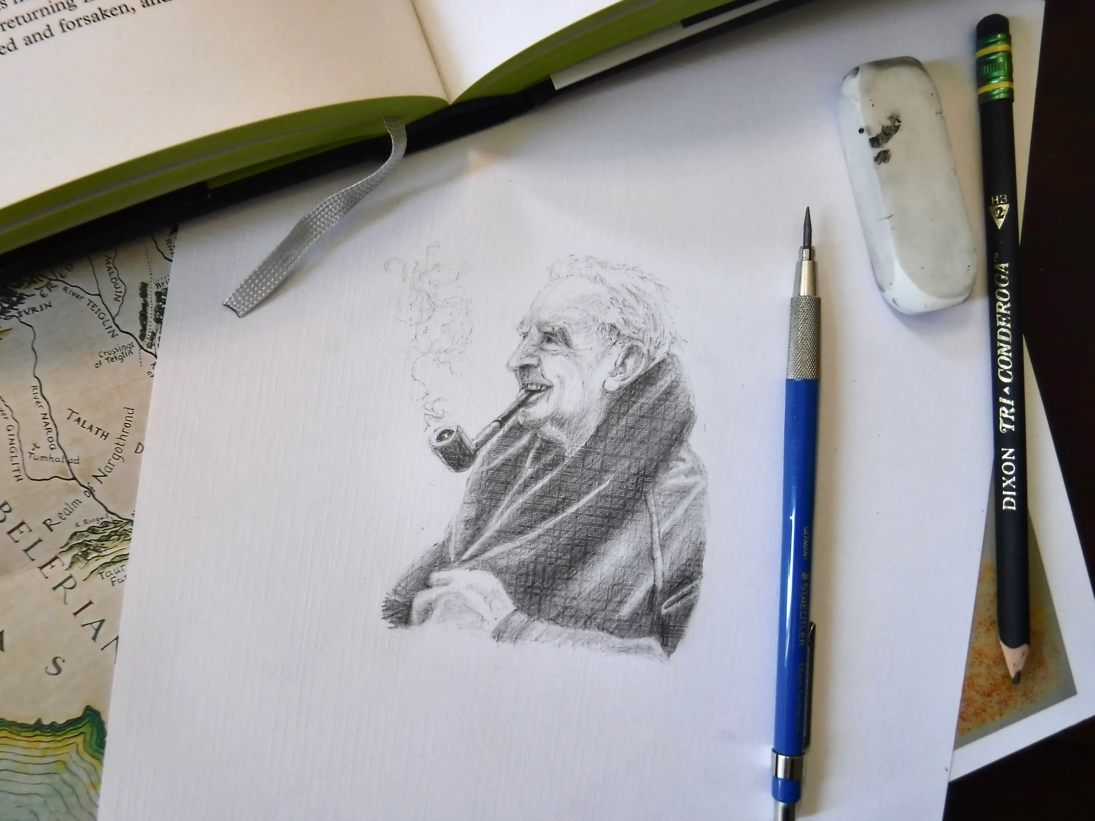 Pencil portrait study of J. R. R. Tolkien on a drawing pad